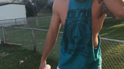 Guy blue shirt hits beer can on head and spills it