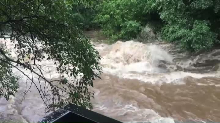 A stream that has become enormously enormous by the pouring rain.