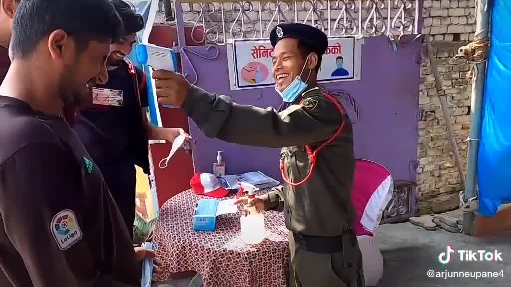 Guy sprays sanitizer into eyes instead of checking temperature.