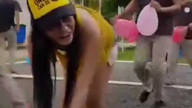 Beautiful girl play funny game with boys