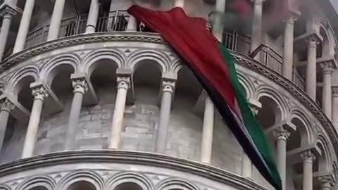 Protesters release flags and smoke bombs from the Tower of Pisa in Italy,