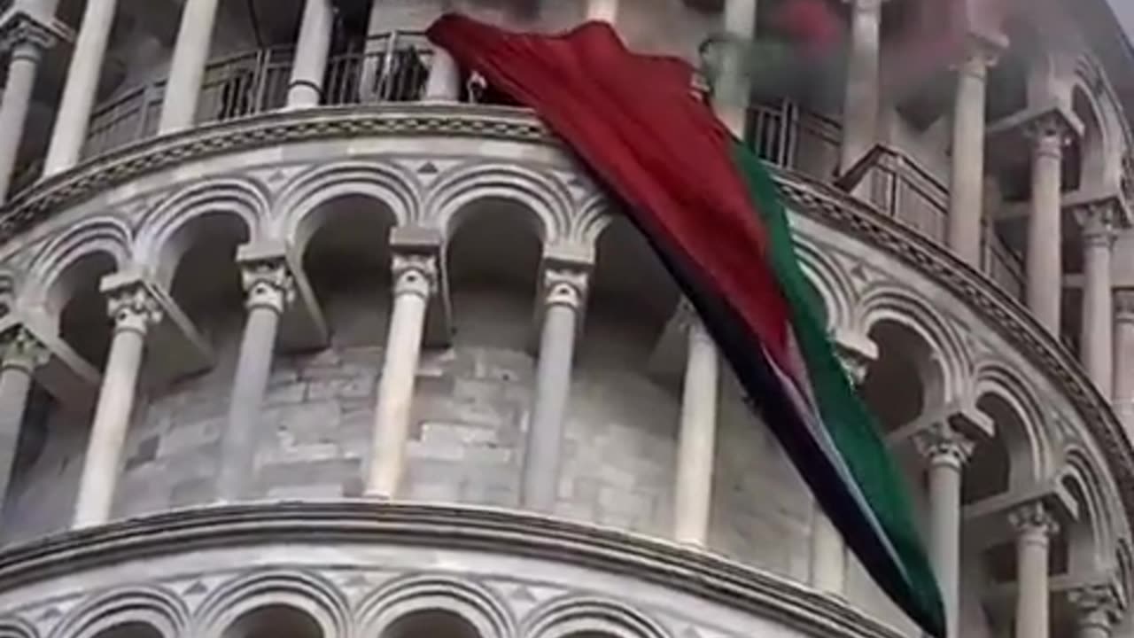 Protesters release flags and smoke bombs from the Tower of Pisa in Italy,