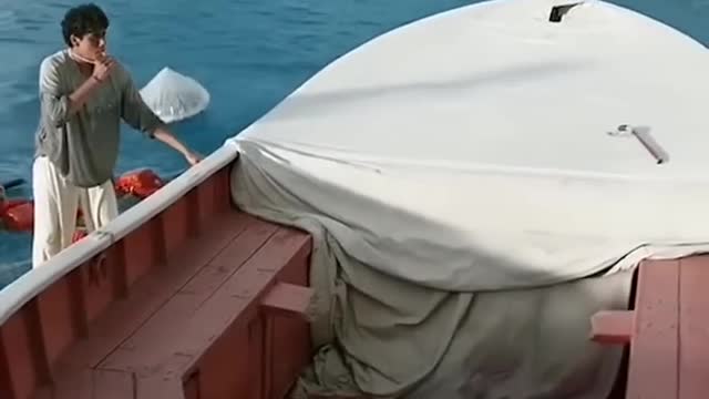 A Teenager And Tiger Drifting On The Sea.