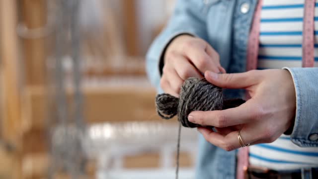 Close up of a Person Winding a Ball of Yarn