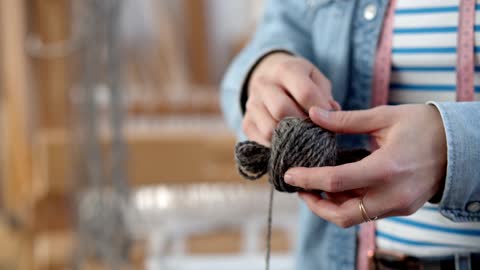Close up of a Person Winding a Ball of Yarn