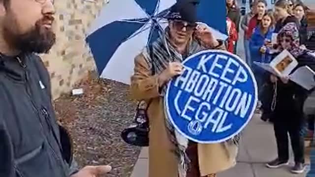 DERANGED PRO-ABORTION PROTESTOR VS CATHOLICS PRAYING