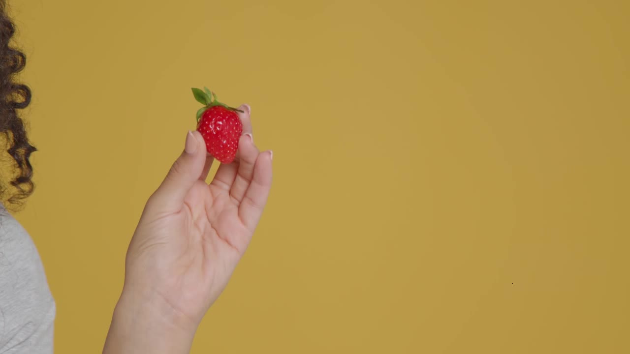 Close Up Shot of Young Adult Woman Holding Strawberry