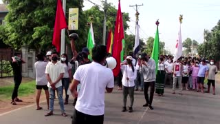 Myanmar marchers carry new year flowers in protest