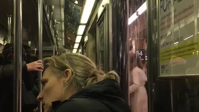 People stare at open subway door water pouring in