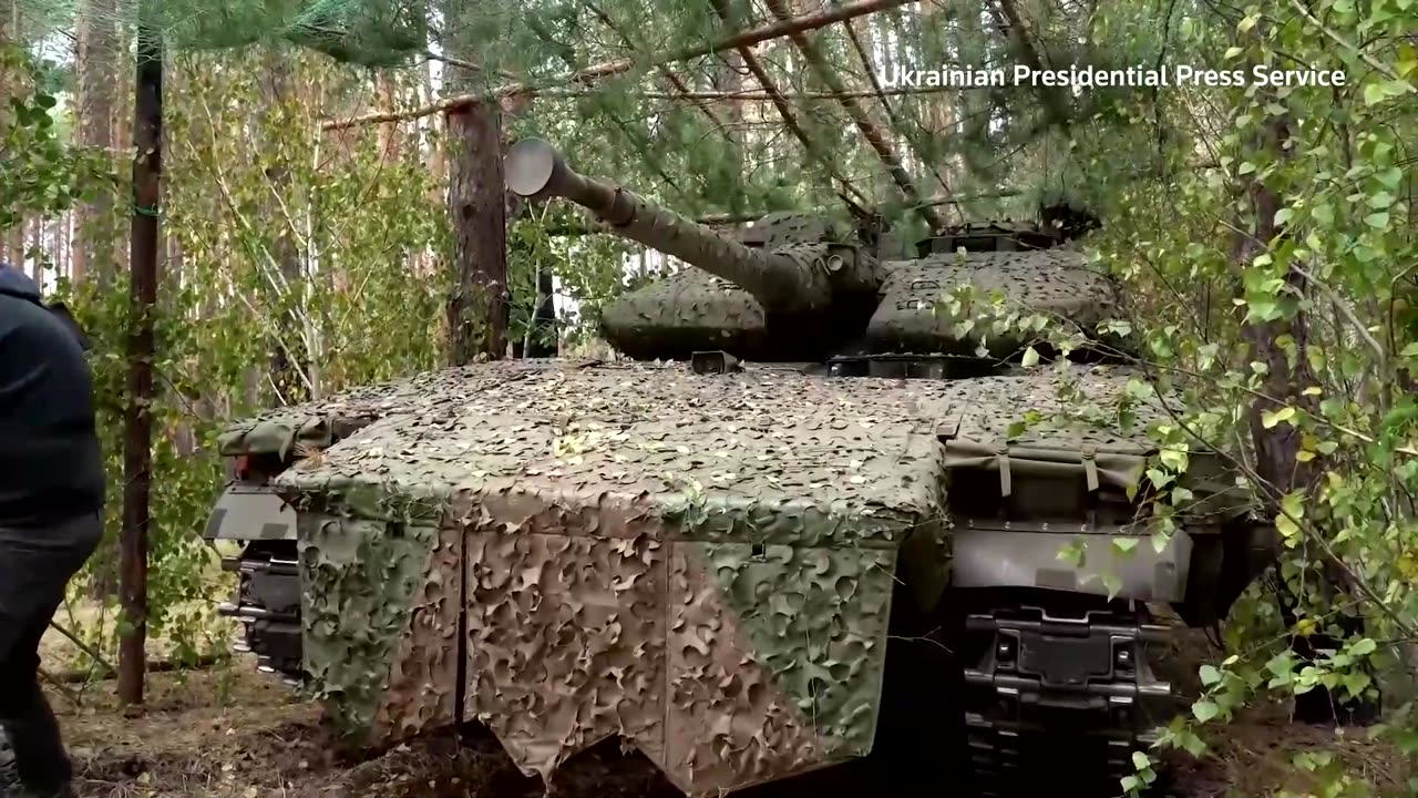 Ukraine's Zelenskiy inspects tanks on the frontline