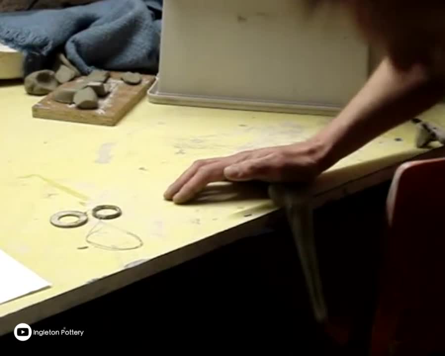 Making a clay pottery tea pot on the wheel