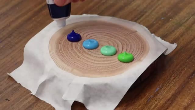 Squeeze Different Colors Of Paint On Wooden Coasters