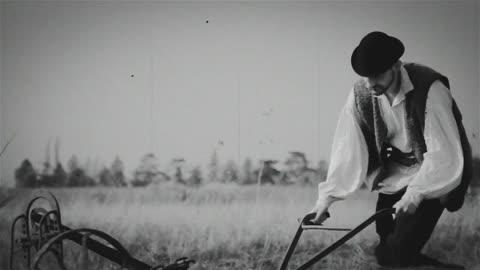 Farmer plowing a field with two horses. Black and white