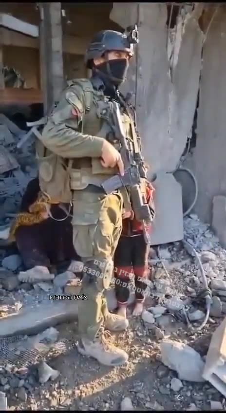 Israeli soldier is comforting a young, Palestinian kid looks like, the horrors of wars