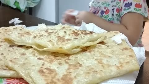 Lovely girl razane eating Moroccan roti canai