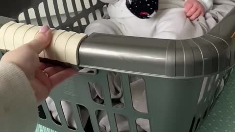 Baby in a washing basket.