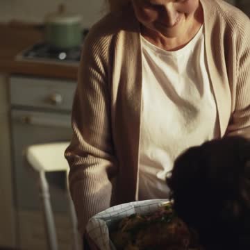 A Woman Serving The Roasted Turkey In The Dining Table