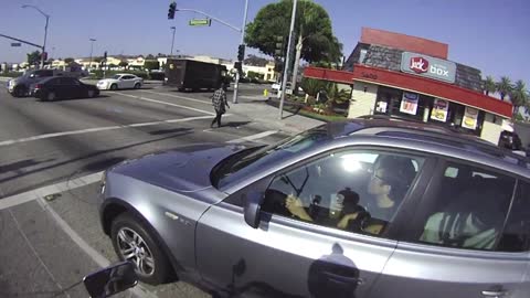 Motorcyclist Startles Driver For Running Red Light