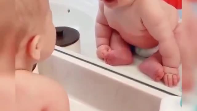 The wonderful shots show the first meeting of the child in a mirror