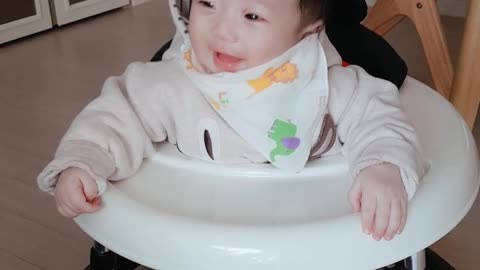 A 145-day-old baby laughs with his aunt.