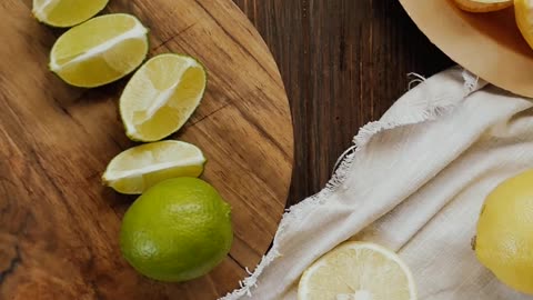 A Person Cutting a Lime into Slices by Using a Knife