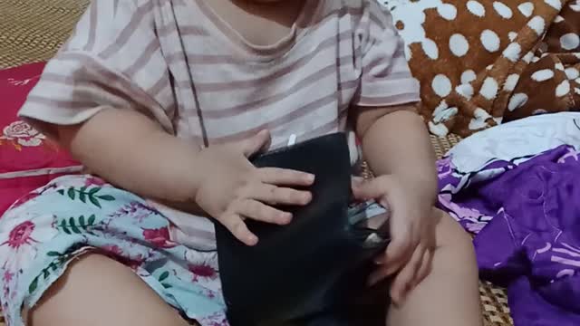 The baby checks his wallet after he comes home to drink