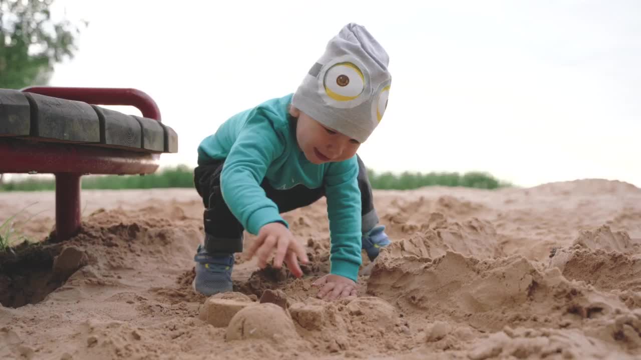 Cute Baby playing with sand..