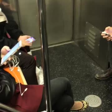 Person playing mobile phone game bejeweled subway