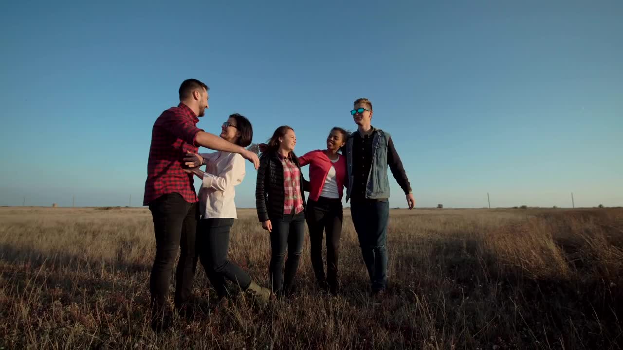 A group of friends standing in the countryside