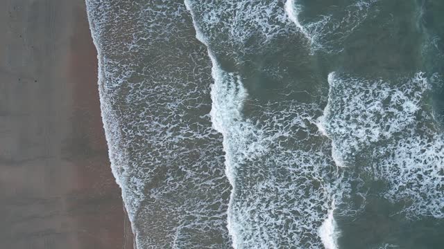 Aerial Footage of Waves Crashing on Shore