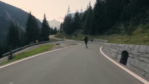 young guy doing skateboarding on the road