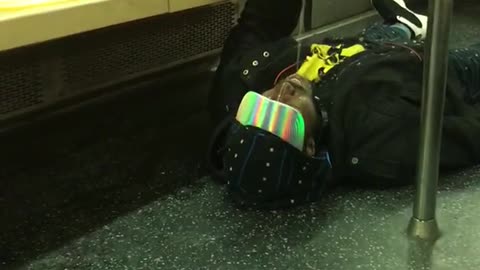 Man on floor pouring water into mouth