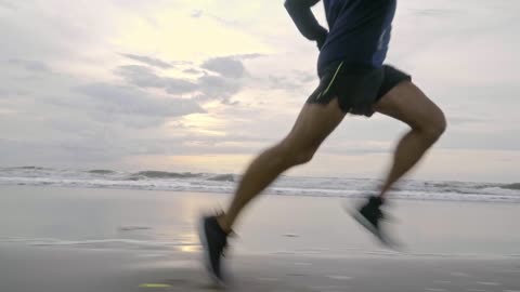 A men running in the beach.