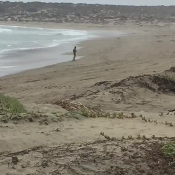 Man dancing practicing moves on beach