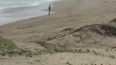 Man dancing practicing moves on beach