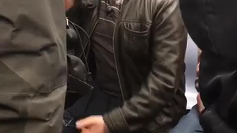 Man in leather jacket heated argument on phone