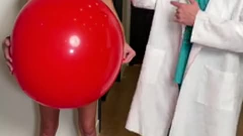 doctor pops nurse's balloon for surprise