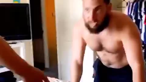 Father and son wrestling on bed