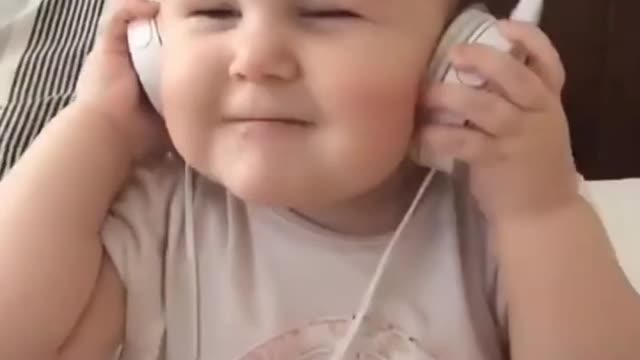 cute baby listening to music and enjoying