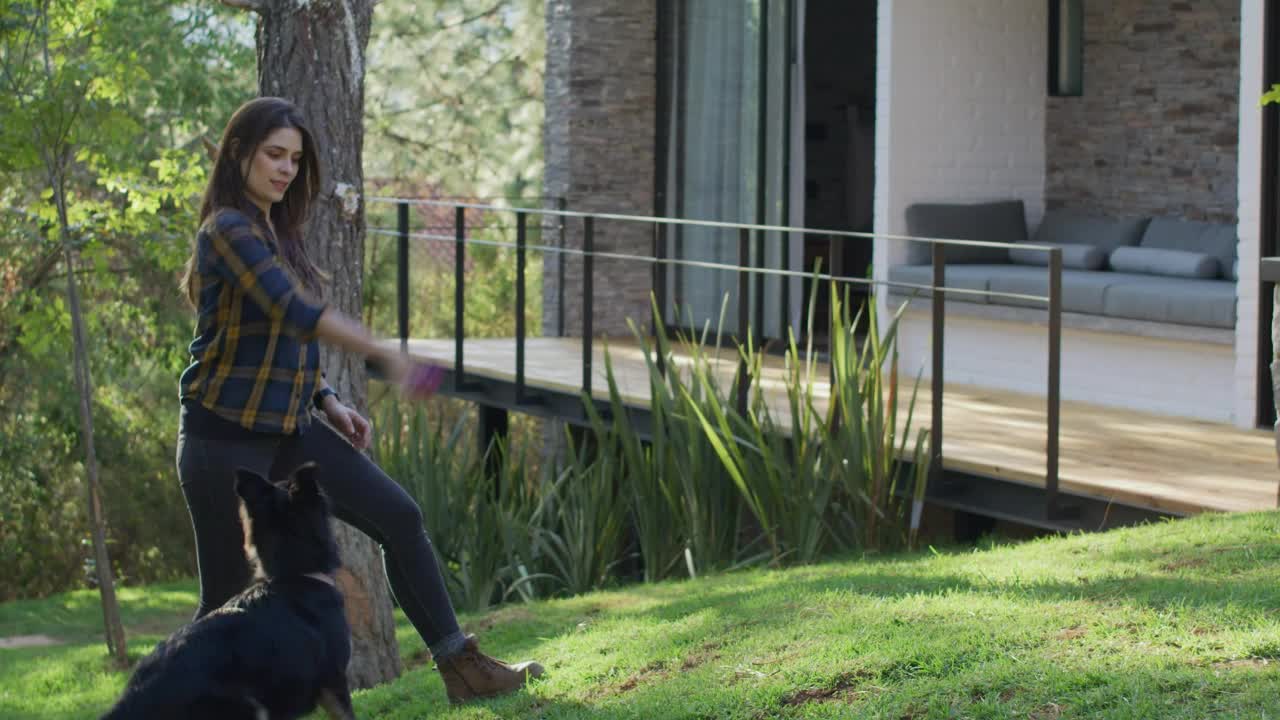 Woman playing with a dog in a garden