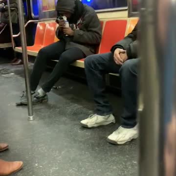 Guy sucks air out of canned air duster on subway train
