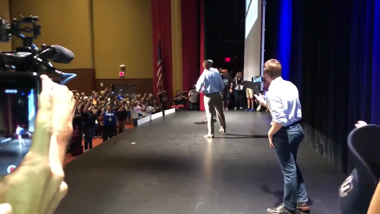 Beto O'Rourke skateboards across the stage