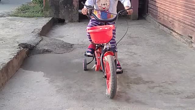 cute little baby riding cycle