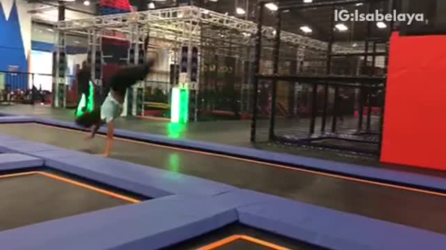 Girl does cartwheel flip inside of trampoline center and lands on head