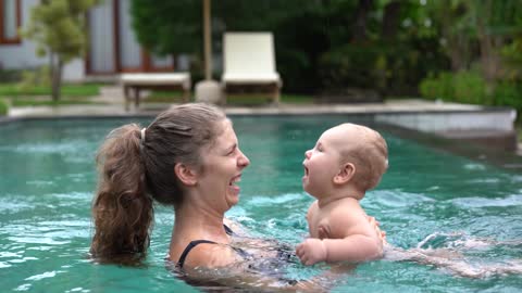 Cute baby on swimming pool | mother | play now