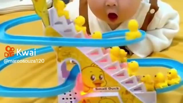 Baby is surprised by toy moving alone
