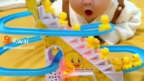 Baby is surprised by toy moving alone