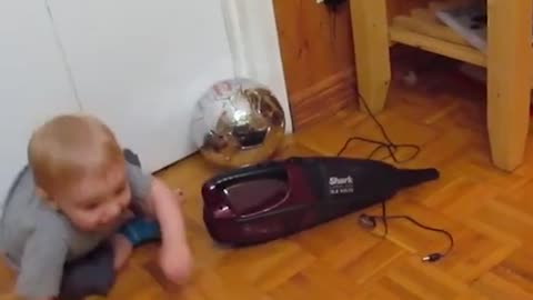 baby plays with dustbuster, freaks out when it turns on