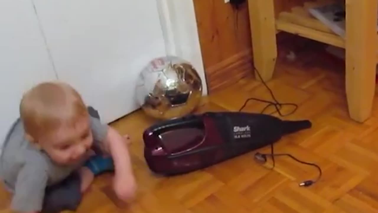 baby plays with dustbuster, freaks out when it turns on