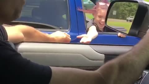 Guy driving touches girl in blue trucks hand